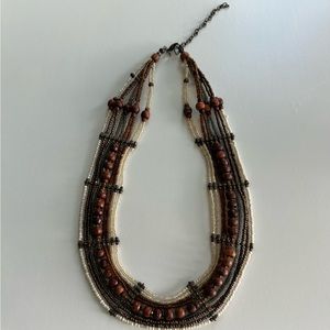 Brown and white multi-strand beaded necklace.